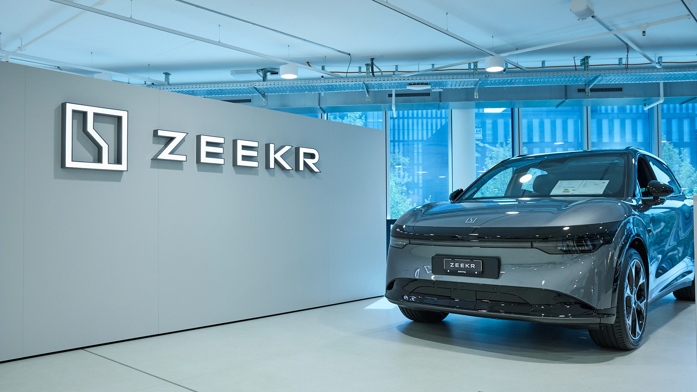 ZEEKR car showroom with an electric car and brand logo in a wide interior view – automotive retail design by Vizona