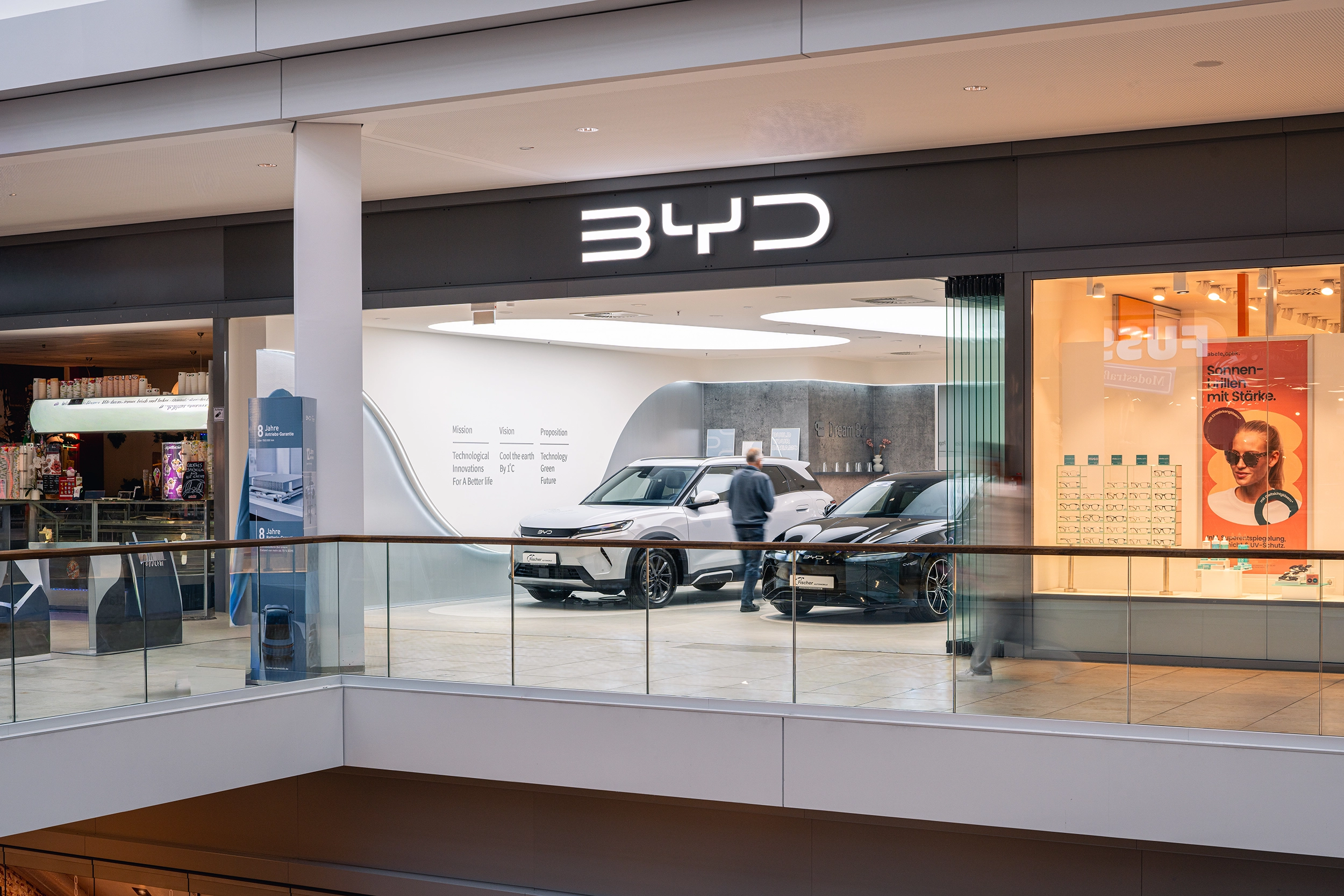 BYD store entrance within a shopping mall with brand signage and electric cars – retail shopfitting by Vizona